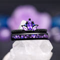 Women's amethyst engagement ring in black sterling silver, stacked on the matching purple inlay band