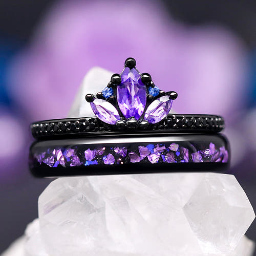 Women's amethyst lotus ring in black sterling silver stacked on a black tungsten band with purple inlay