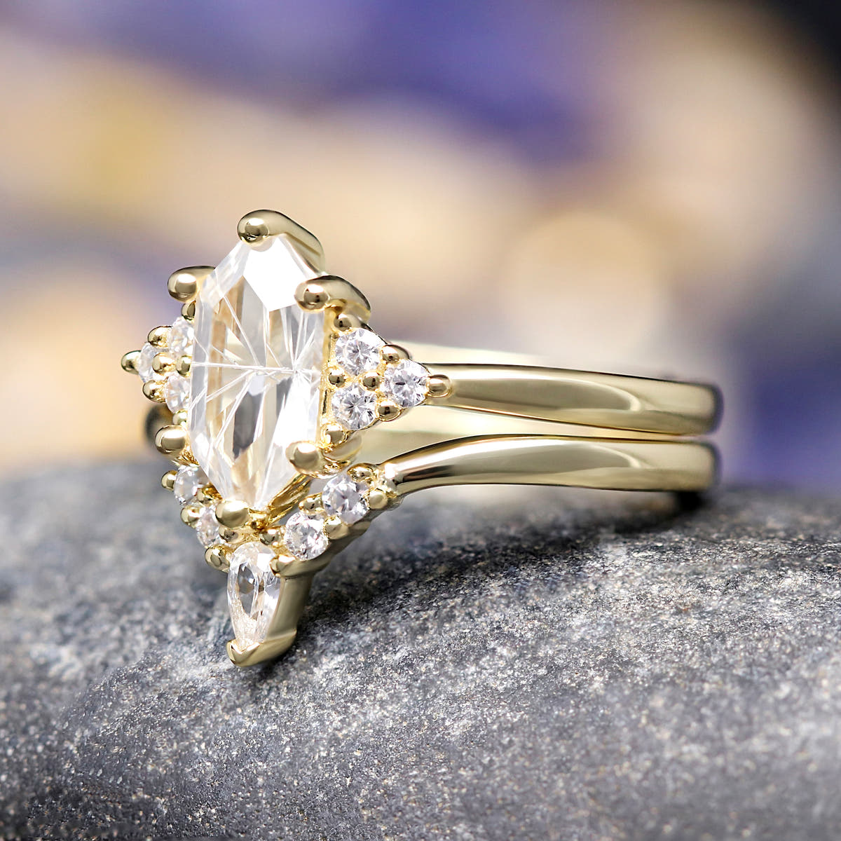 Angled side view of the elongated hexagon white sapphire ring and curved gold band