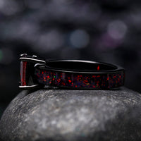 Matching his and her black wedding bands with gemstones