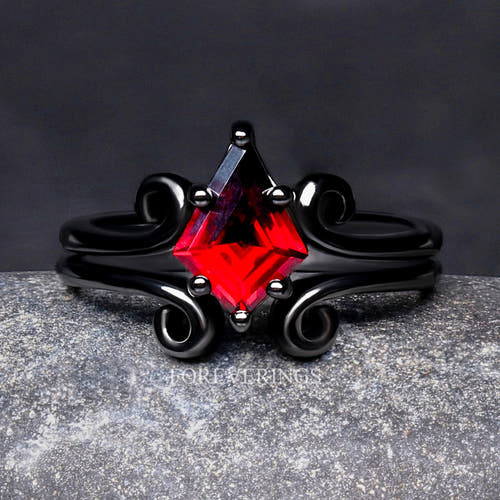 Women's black sterling silver kite-cut garnet ring with swirl details, close front view