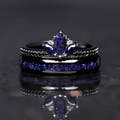 Black lotus ring stacked on a 4mm black tungsten band with blue sandstone inlay, front view