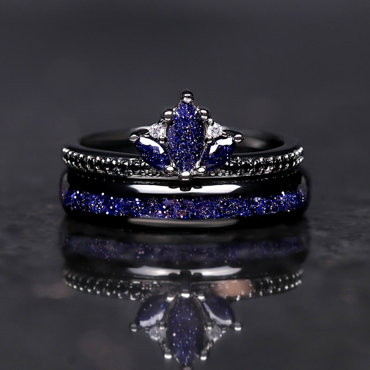 Black lotus ring stacked on a 4mm black tungsten band with blue sandstone inlay, front view