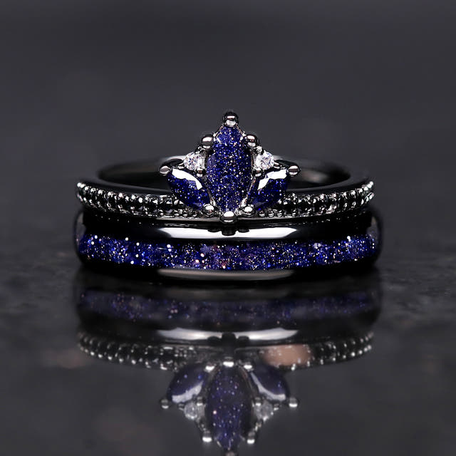 Black lotus ring stacked on a 4mm black tungsten band with blue sandstone inlay, front view