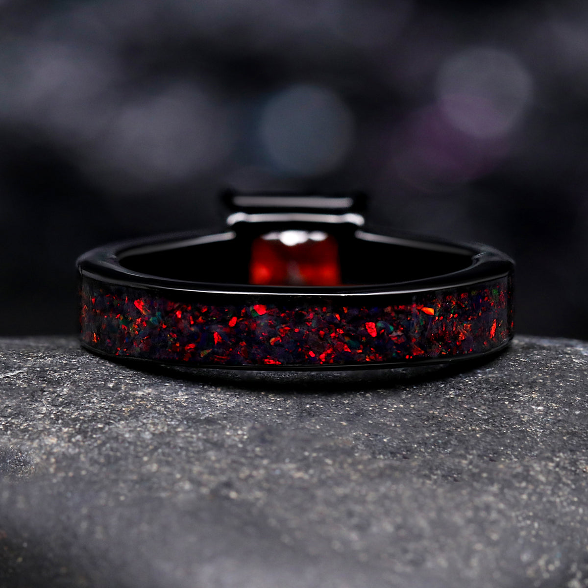 Couples engagement and wedding rings with black fire opal