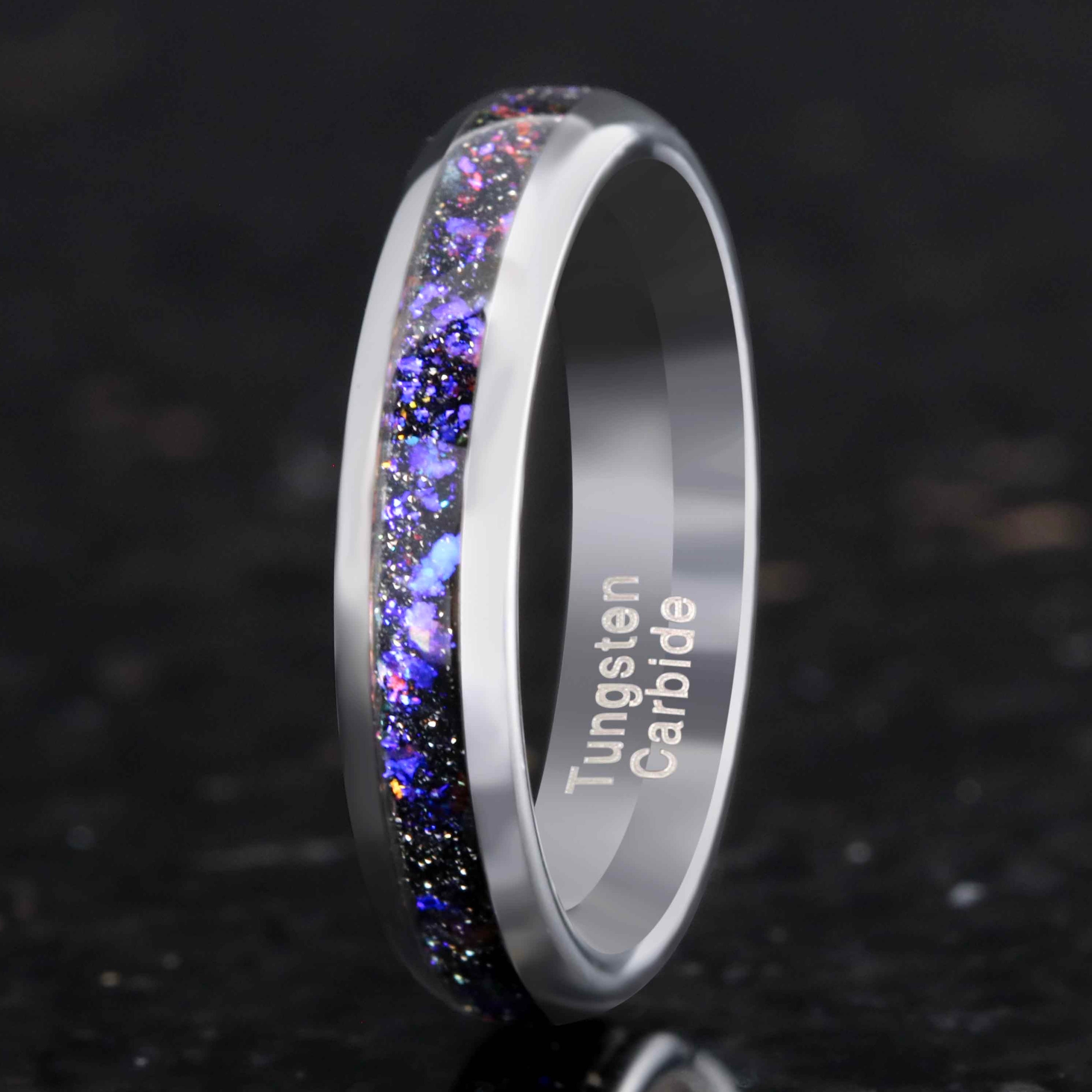 Tungsten carbide ring with colorful inlay on a dark background