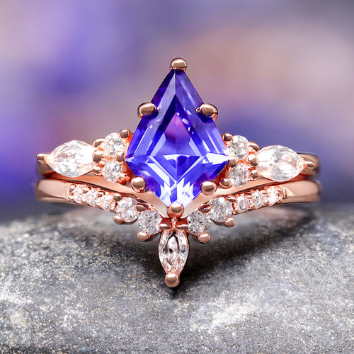 Women's rose gold sterling silver bridal set with a kite-cut sapphire and curved band, close-up