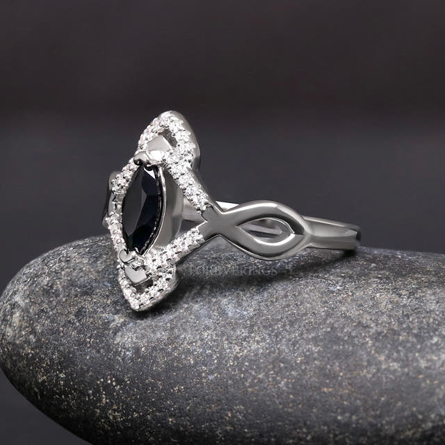 Marquise black stone ring in sterling silver, angled side view showing the twisted band