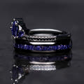 Black lotus ring with blue sandstone stacked on a black tungsten sandstone band, side view