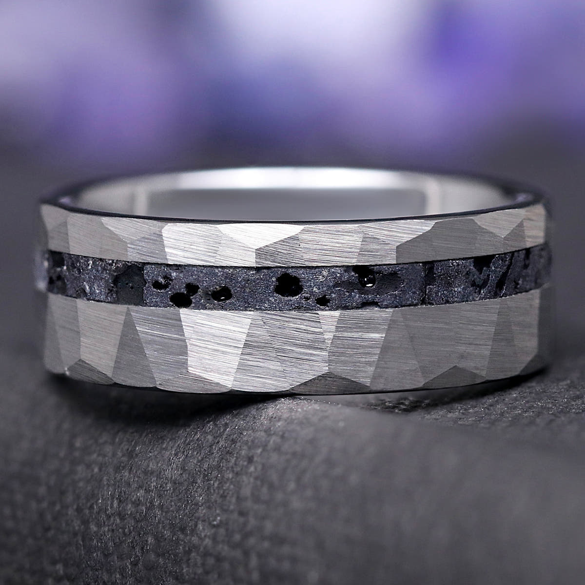 Men's 8mm hammered silver tungsten wedding band with volcanic lava rock inlay, close crop