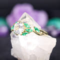 Gold white sapphire engagement ring with a twisting vine band, angled side view