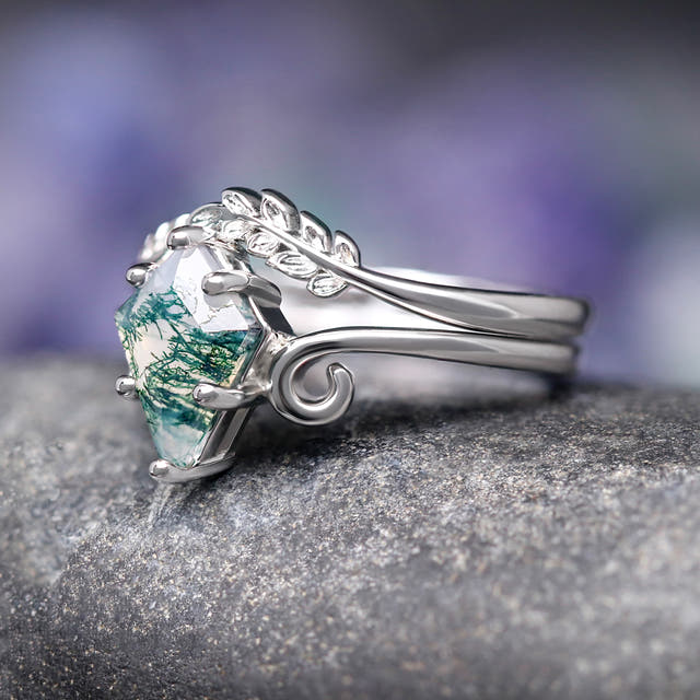 Sterling silver moss agate ring and leaf band from an angle, showing the prongs and swirls
