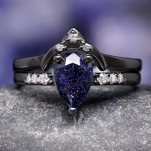 Women's black sterling silver pear-cut blue sandstone bridal set with a curved band, close crop