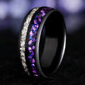 Black ring with purple and white gemstones on a dark background