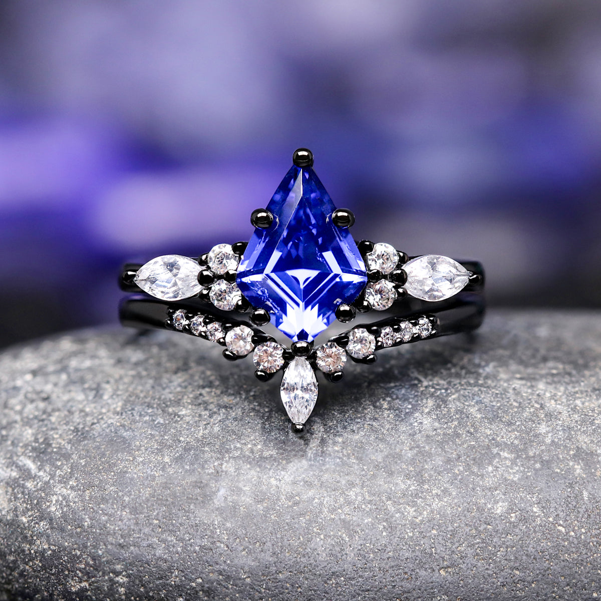 Blue gemstone ring with black band and diamonds