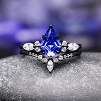 Blue gemstone ring with black band and diamonds