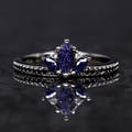 Black sterling silver lotus ring with a marquise blue sandstone center, shown straight on
