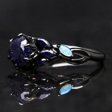 Women's black sterling silver blue sandstone ring with marquise opal leaf accents, angled view