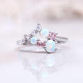 Women's sterling silver cluster ring with white opals and pink morganite, shown straight on
