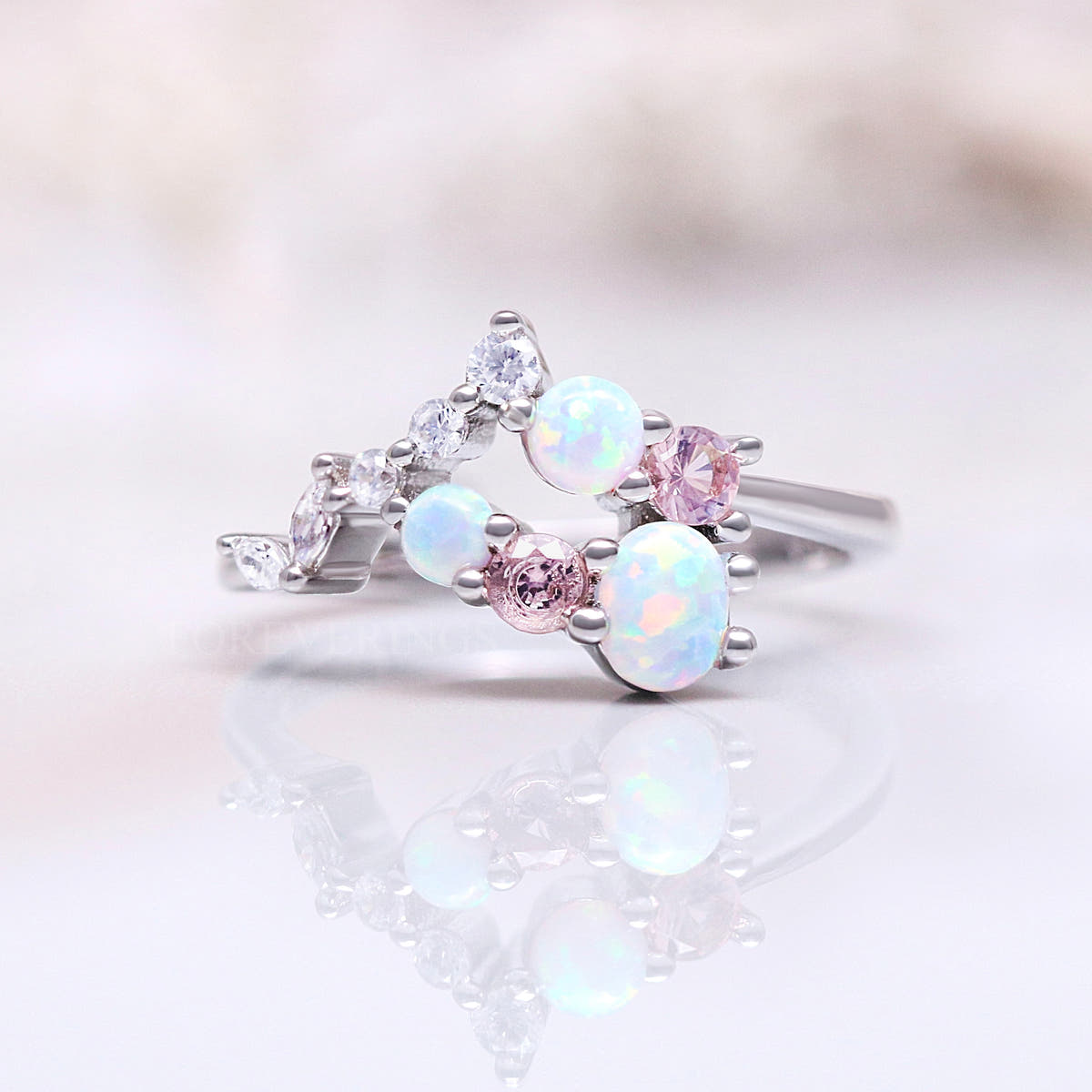 Women's sterling silver cluster ring with white opals and pink morganite, shown straight on