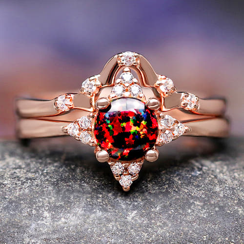 Women's rose gold sterling silver bridal set with a round black fire opal, shown straight on