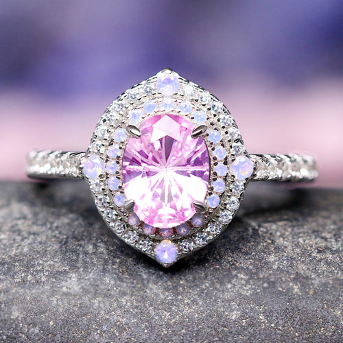 Women's sterling silver oval lab pink sapphire engagement ring with halo, shown straight on
