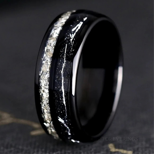 Men's 8mm black tungsten ring with crushed diamond and silver flake inlay, close-up standing view