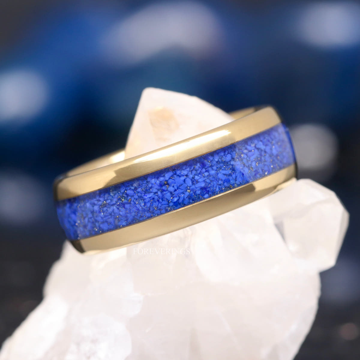Men's 8mm gold tungsten wedding band with crushed lapis lazuli inlay, angled view