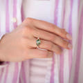 Moss agate ring in rose gold sterling silver, worn on a woman's hand