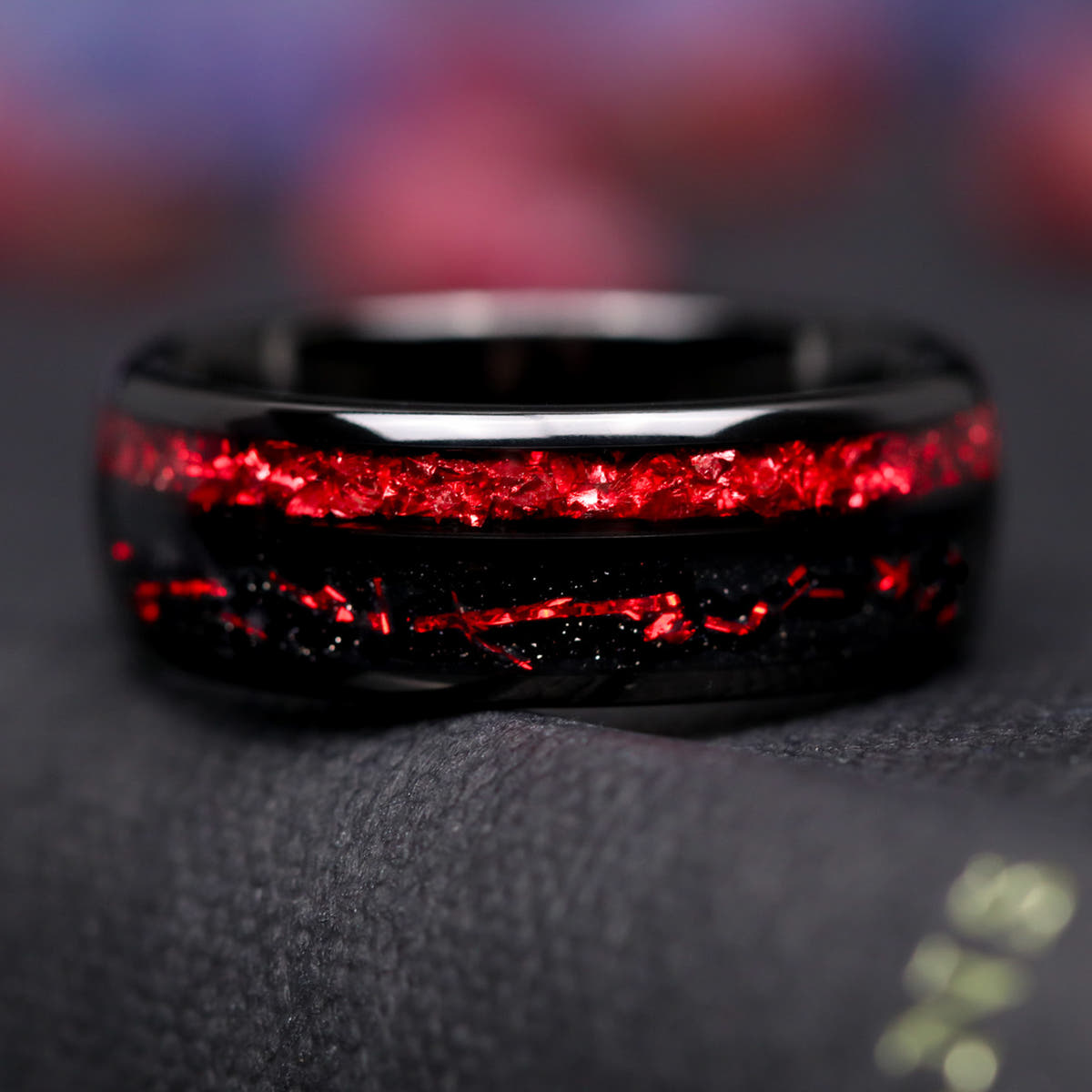 Men's 8mm black tungsten wedding band with two stripes of ruby inlay, shown straight on
