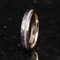 Women's 4mm hammered silver tungsten ring with white fire opal inlay, rose gold inside, standing on edge