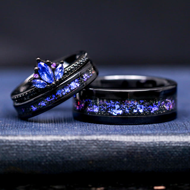 Blue sapphire lotus ring leaning on black tungsten bands with nebula inlay