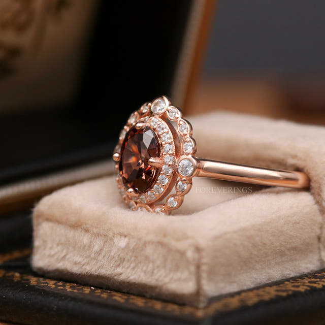 Rose gold smoky quartz halo engagement ring in a ring box, angled side view