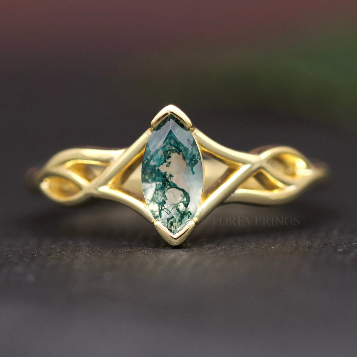 Women's gold sterling silver moss agate engagement ring with a marquise stone, straight on