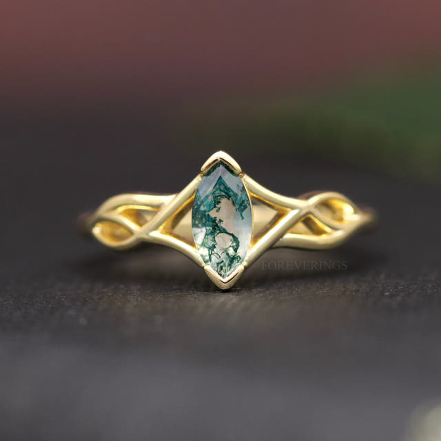 Women's gold sterling silver marquise moss agate ring with a twisted band, shown straight on
