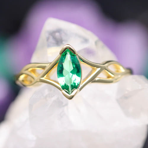 Women's gold sterling silver Celtic knot ring with a marquise emerald, close crop
