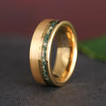 Men's 8mm gold tungsten band with a moss agate inlay strip, standing at an angle