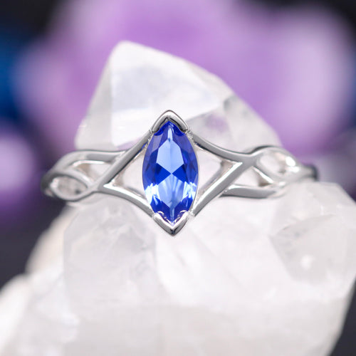 Celtic knot engagement ring in sterling silver with a marquise blue sapphire, front view