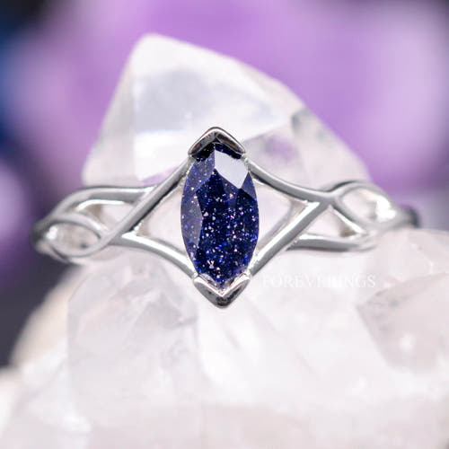 Women's sterling silver Celtic knot ring with a marquise blue sandstone, shown straight on