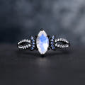 Women's black sterling silver marquise moonstone ring with blue crescent moon accents, straight on