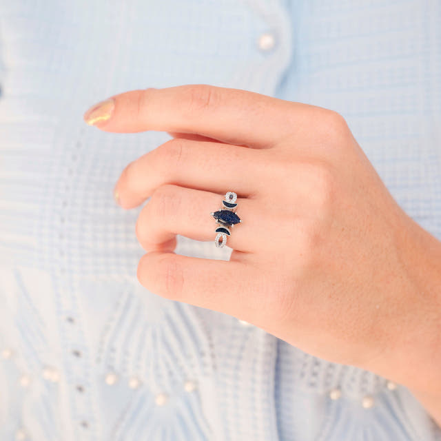 Women's sterling silver blue sandstone marquise ring worn on a hand