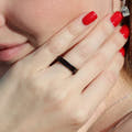 Crushed black fire opal tungsten band worn on a woman's hand, his and hers set