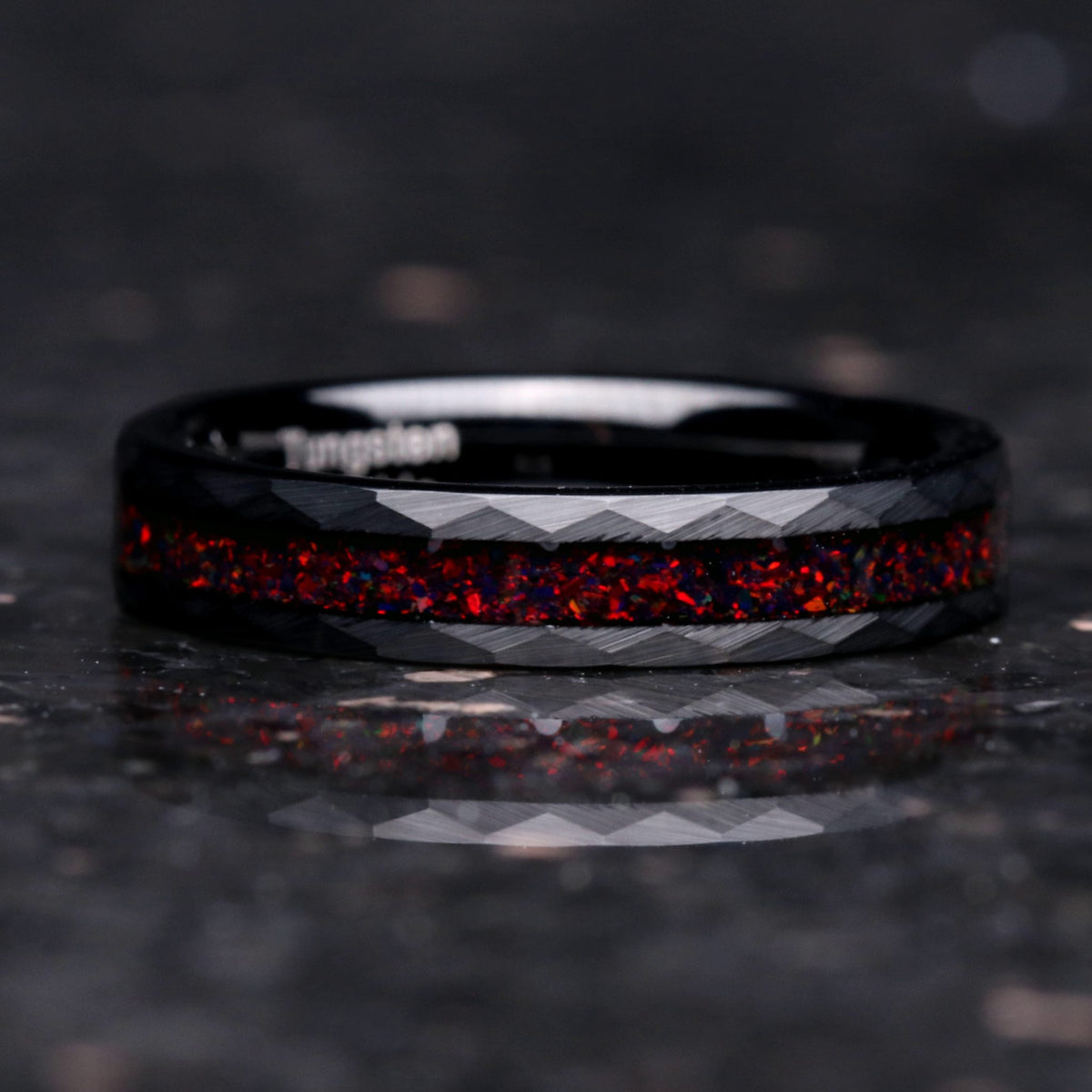 Crushed black fire opal hammered black tungsten band on black background