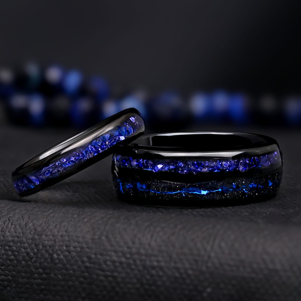 Matching black tungsten couples ring set with crushed blue sapphire inlays, 8mm and 4mm