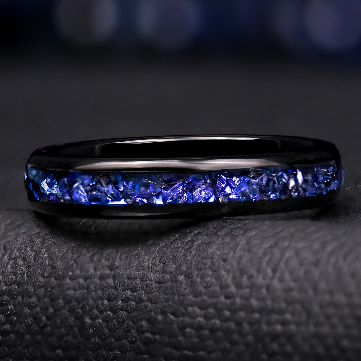 Women's 4mm black tungsten band with a channel of crushed blue sapphire, shown straight on
