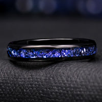 Women's 4mm black tungsten band with a channel of crushed blue sapphire, shown straight on
