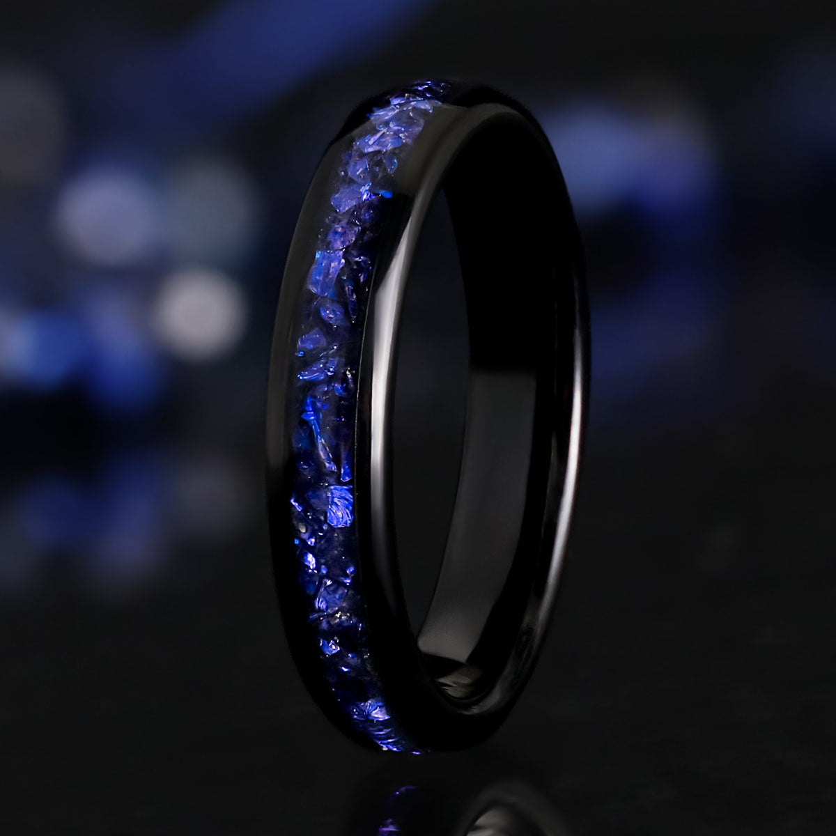4mm black tungsten ring with a crushed blue sapphire inlay, standing at an angle
