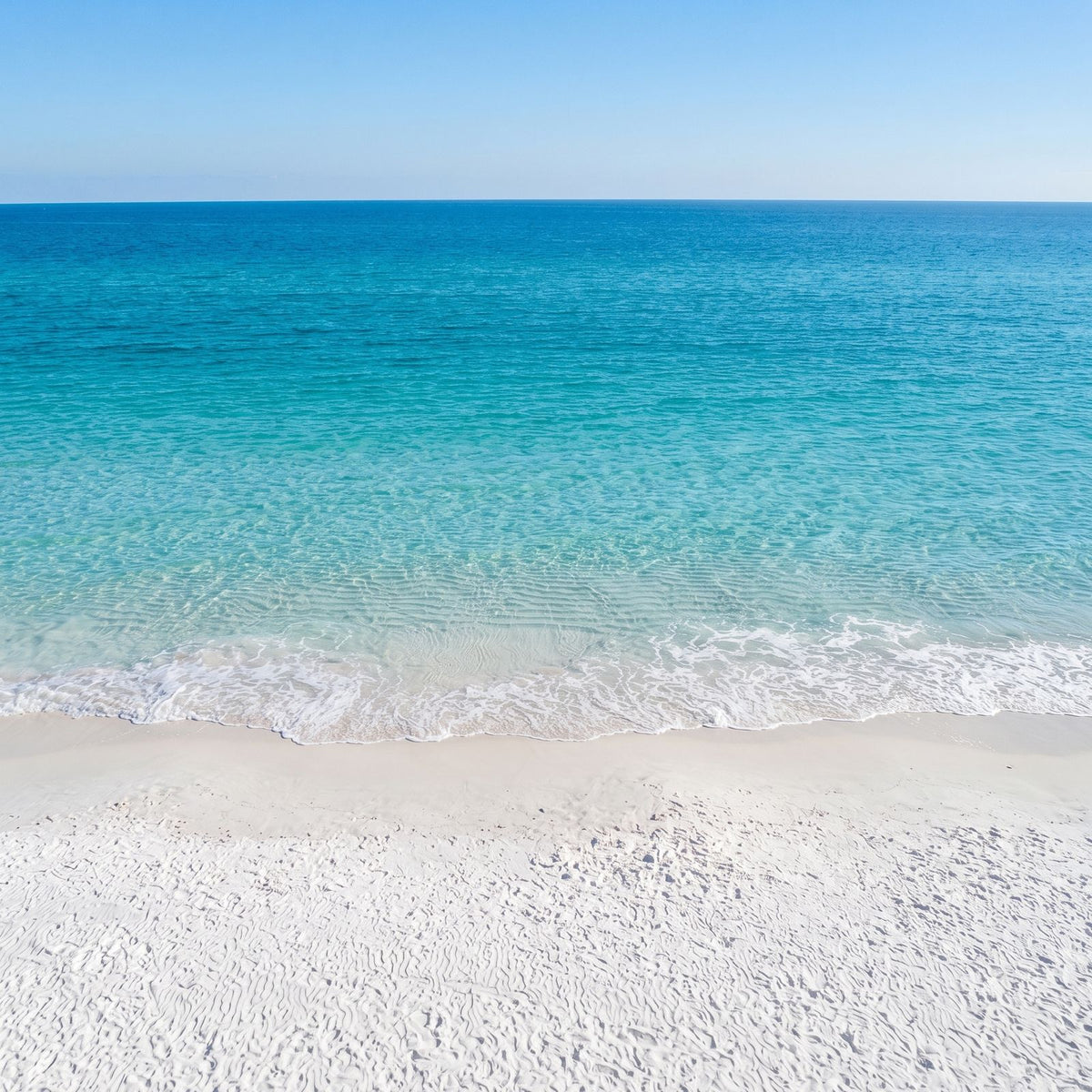 White sand beach and turquoise Emerald Coast water, the inspiration for the Emerald Coast opal ring