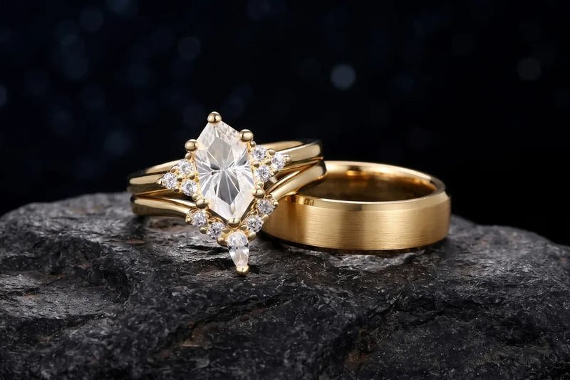 Couple trying on matching gold rings: her stone-set engagement ring and his brushed gold band