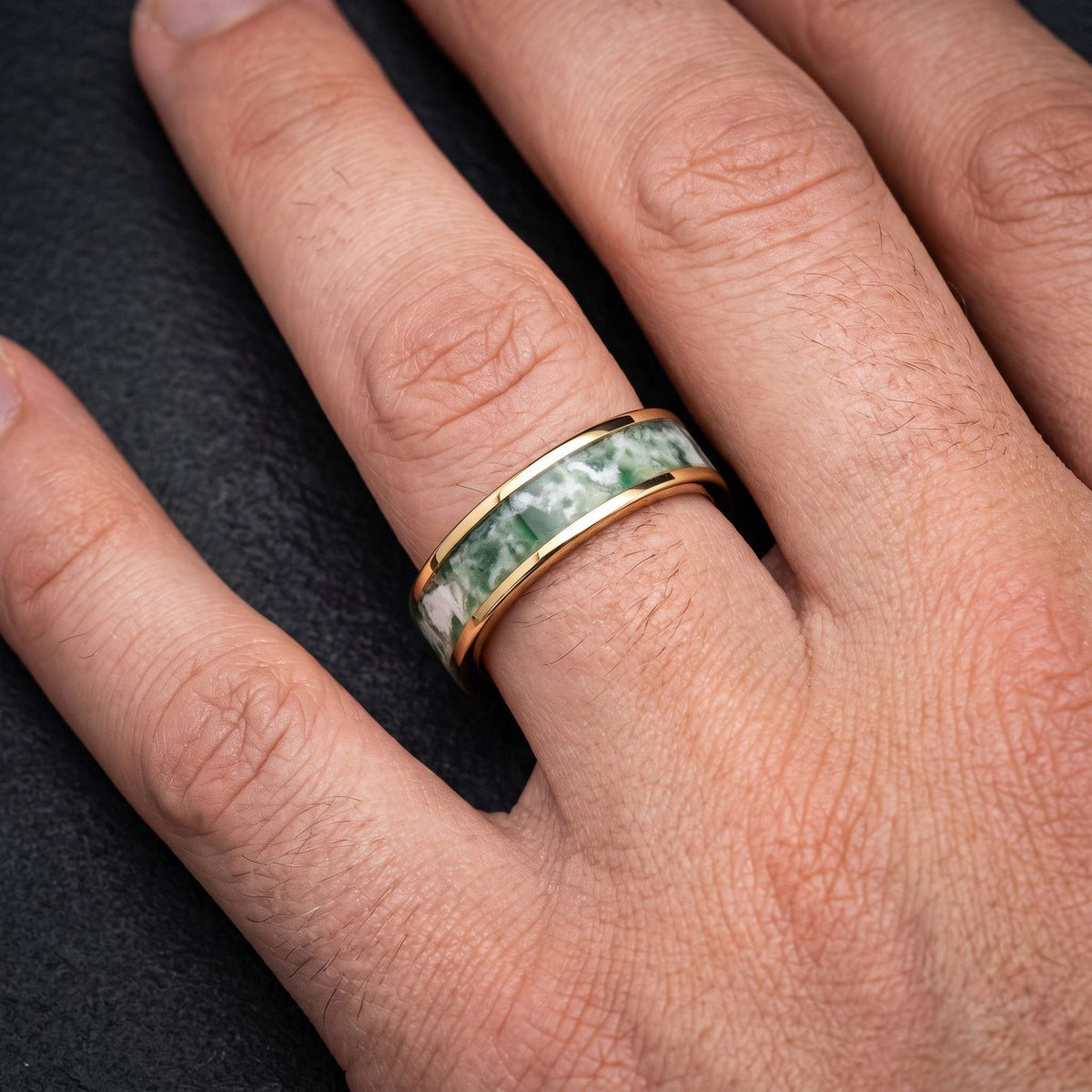 Men's gold moss agate ring with green inlay worn on hand